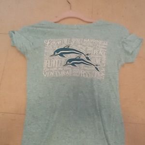 Blue shirts with two dolphins that has inspiring words on it